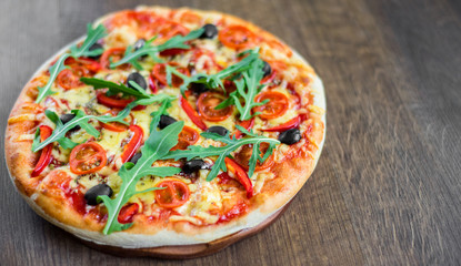 Pizza Margherita or Margarita with Mozzarella cheese, tomato, olive. Italian pizza on wooden background