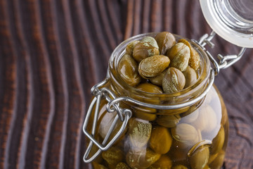 pickled capers on a wooden rustic background