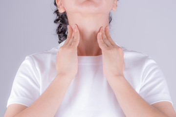 Healthcare and medical concept. Sore Throat. Closeup Of Beautiful Young Woman Hand Touching Her Ill Neck.
