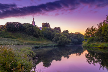 Fototapeta na wymiar Church on the river at sunrise