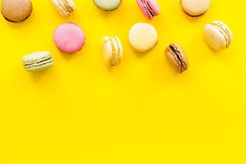 sweet dessert pattern with macarons on yellow background flat lay mockup