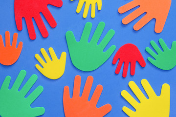 Fototapeta premium Abstract background of funky foam hands cutouts of different sizes in red, orange, yellow, green and blue