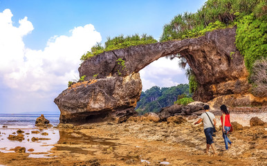 Neil island sea beach Andaman with natural rock formation and view of couple tourist enjoying a moment in solitude
