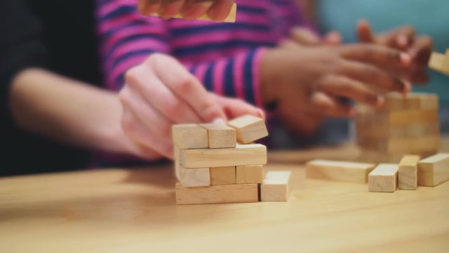 Close up of hands building jenga tower