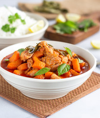 Thai Red Chicken Curry iwith Vegetable in a Bowl on White Background. Thai Cuisine, Oriental Cuisine, Asian Food, Non Veg Side Dish Concept.