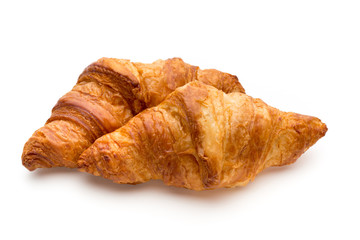 Tasty buttery croissants on the white background.
