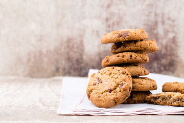 Chocolate oatmeal cookies on the wooden background.