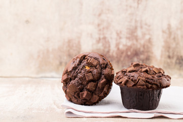 Homemade muffins with chocolate, vintage background.