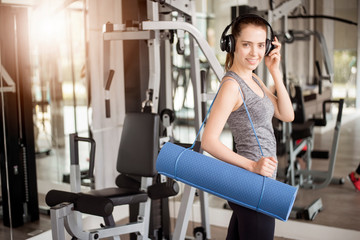 Fototapeta premium Pretty young sport woman is workout with mat in gym, Healthy lifestyle