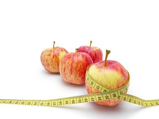 Group of red and yellow apple with yellow weight tape scale isolated on white background, dieting of human concept.