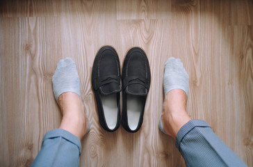 Shoes and socks on the background of the parquet. Morning groom. Wedding details. Concept and composition.