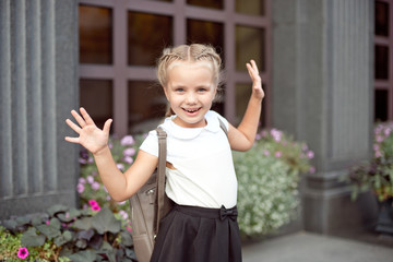 Happy smiling girl is going to school for the first time with bag go to elementary school.