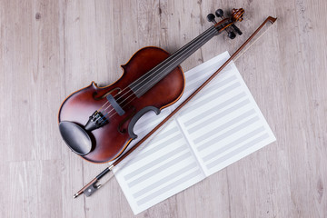 Obraz na płótnie Canvas Classical violin with empty music sheet book. Studio shot of old violin. Classical musical instrument