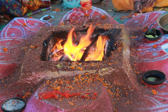 Bhadrak, Odisha, India. 13th April, 2019.Homa is concluded with a Purnahuti, Aarthi and offering the Thamboolam and cuconuts to Lord Agni. Priests continue with the last of the mantras. motion blur