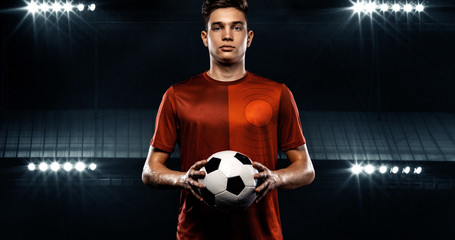 Teenager - soccer player. Boy in football sportswear after game with ball. Sport concept.
