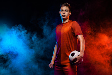 Teenager - soccer player. Boy in football sportswear after game with ball. Sport concept.