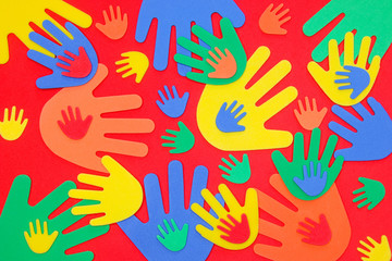 Abstract background of funky foam hands cutouts of different sizes in red, orange, yellow, green and blue