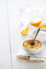Trendy healthy homemade citrus lemon jam or confiture in a bowl on a white wooden background with copy space for text.Delicious dessert for Breakfast. Fruit preservation.Vertical orientation