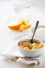 Trendy healthy homemade citrus lemon jam or confiture in a bowl on a white wooden background.Delicious dessert for Breakfast. Fruit preservation.Vertical orientation