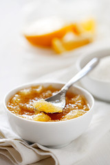 Trendy healthy homemade citrus lemon jam or confiture in a bowl on a white wooden background close-up.Delicious dessert for Breakfast. Fruit preservation.Vertical orientation