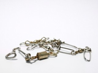 Obraz premium Closeup and macro shot of fishing accessories, fishing hock and fishing s,crimps,equipment,fish,fisherman,fishing,fishing hook,fishing swivel,hard,hole,hook,icon,isolated,jig,leisure,line,loop,metal,m