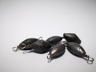 Closeup and macro shot of weighted fishing equipment with white background. 