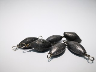 Closeup and macro shot of weighted fishing equipment with white background. 