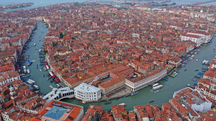 Aerial drone photo of iconic and unique Ponte Rialto or Rialto bridge crossing Grand Canal, Venice, Italy