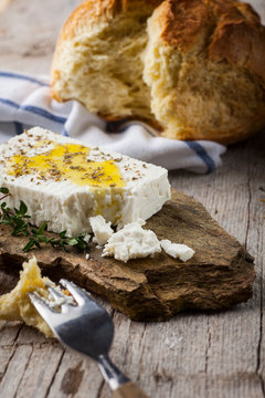feta cheese on a stone plater with bread