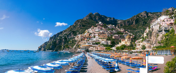 wide panorama Positano, Italy - Beach with umbrellas, Amalfi coast, vacation concept