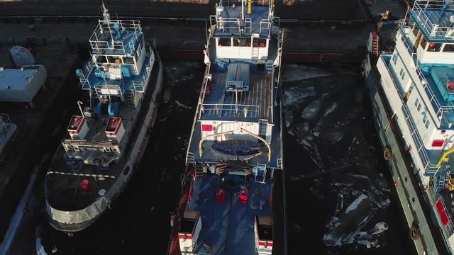 parking of ships in the port on the river, aerial shooting from a copter