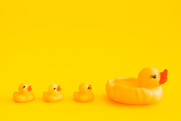 Yellow rubber duck isolated on a yellow background.
