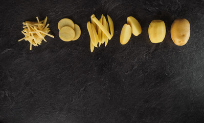 Different cuts of potatoes on a black textured background.