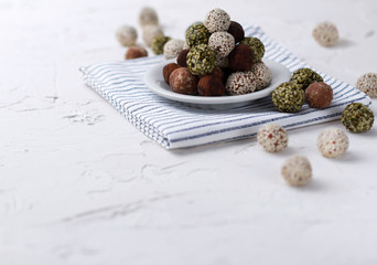 Homemade organic healthy raw energy sweet balls on a plate with a napkin.