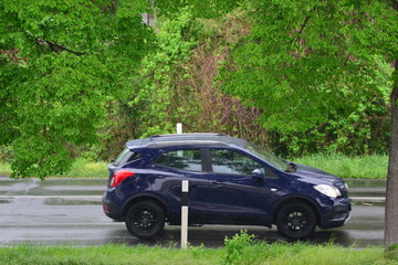 Fast moving blurred car in germany on a rainy day in april