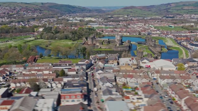 Long shot aerial orbit hyperlapse of Caerphilly Castle north of Cardiff, South Wales. Filmed on a Spring April morning with blue skies and bright sunshine on the DJI Mavic 2 Pro from DNG raw stills.