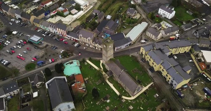 Ireland Aerial, flying over streets of Raphoe, ruins of Caislean Rath Bhoth coming into view