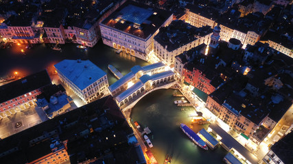 Aerial night shot of beautiful illuminated Grand Canal with colourful Gondolas and boats, Venice,...
