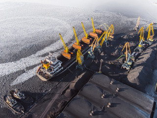 Industrial photo, Loading coal mining in port ship with crane. Aerial top view