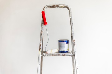 painting roller with color can on metal ladders. 