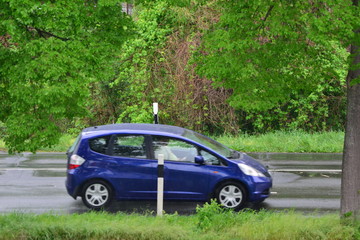 Fast moving blurred car in germany on a rainy day in april