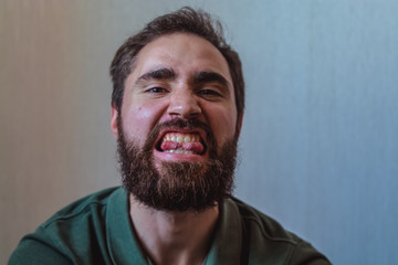 Fototapeta premium Various emotions on a face at the young bearded European man. Different mood.