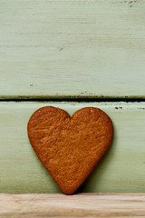 heart-shaped cookie on a pale green background