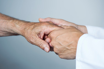 Fototapeta premium man moving the hand of a senior patient