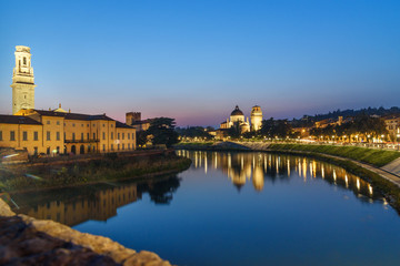 View from Ponte Pietra on Adige River and city at night. Verona. Italy