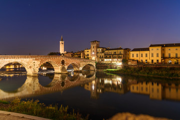 Obraz premium Ponte Pietra over Adige River and city at night. Verona. Italy