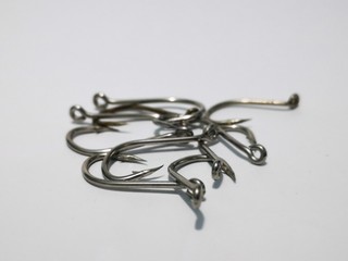 Closeup and macro shot of fishing accessories, fishing hock and fishing swivel with white background. 