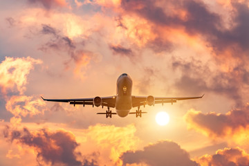 Evening flight, completion of the flight of the airplane, landing at the airport at sunset and beautiful sky.