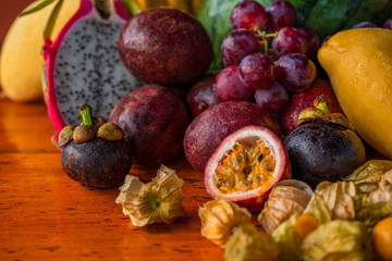 Exotic fruits on wooden table still life