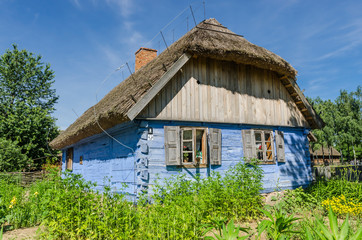 Fototapeta na wymiar Traditional wooden cottage on a farm at the Museum of the Mazovian Countryside